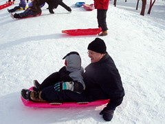 PF and Robbie ready to go down the hill in a sled.