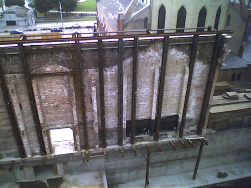 A brick wall being saved to be used as part of a new building